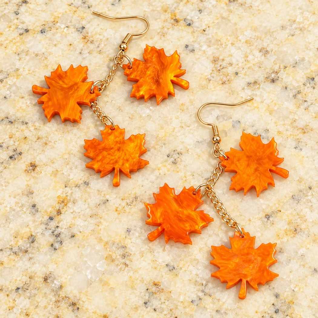 Orange maple leaf dangle earrings in acrylic with triple leaf drop design