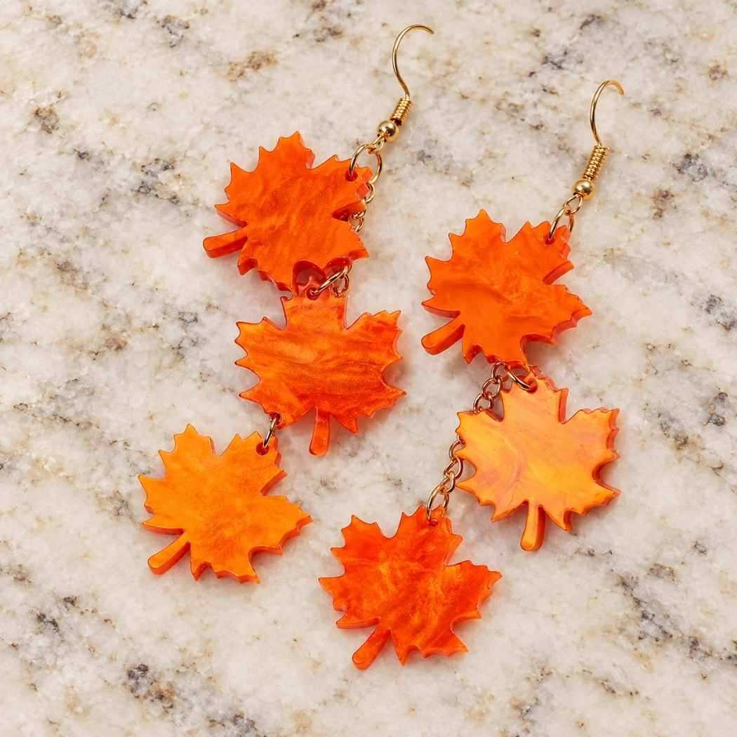 Orange maple leaf dangle earrings in acrylic with triple leaf drop design
