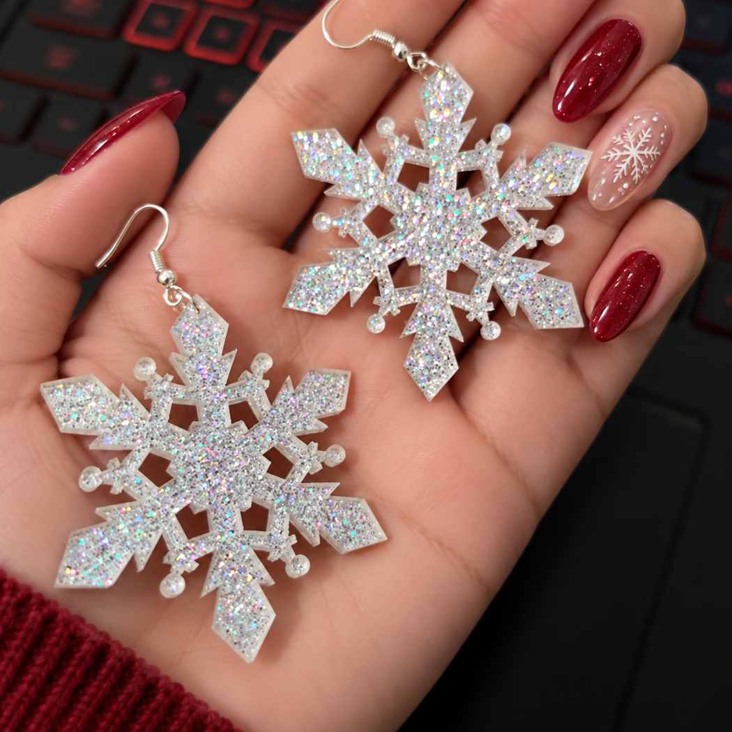 Silver glitter acrylic snowflake statement earrings worn with a cream winter outfit