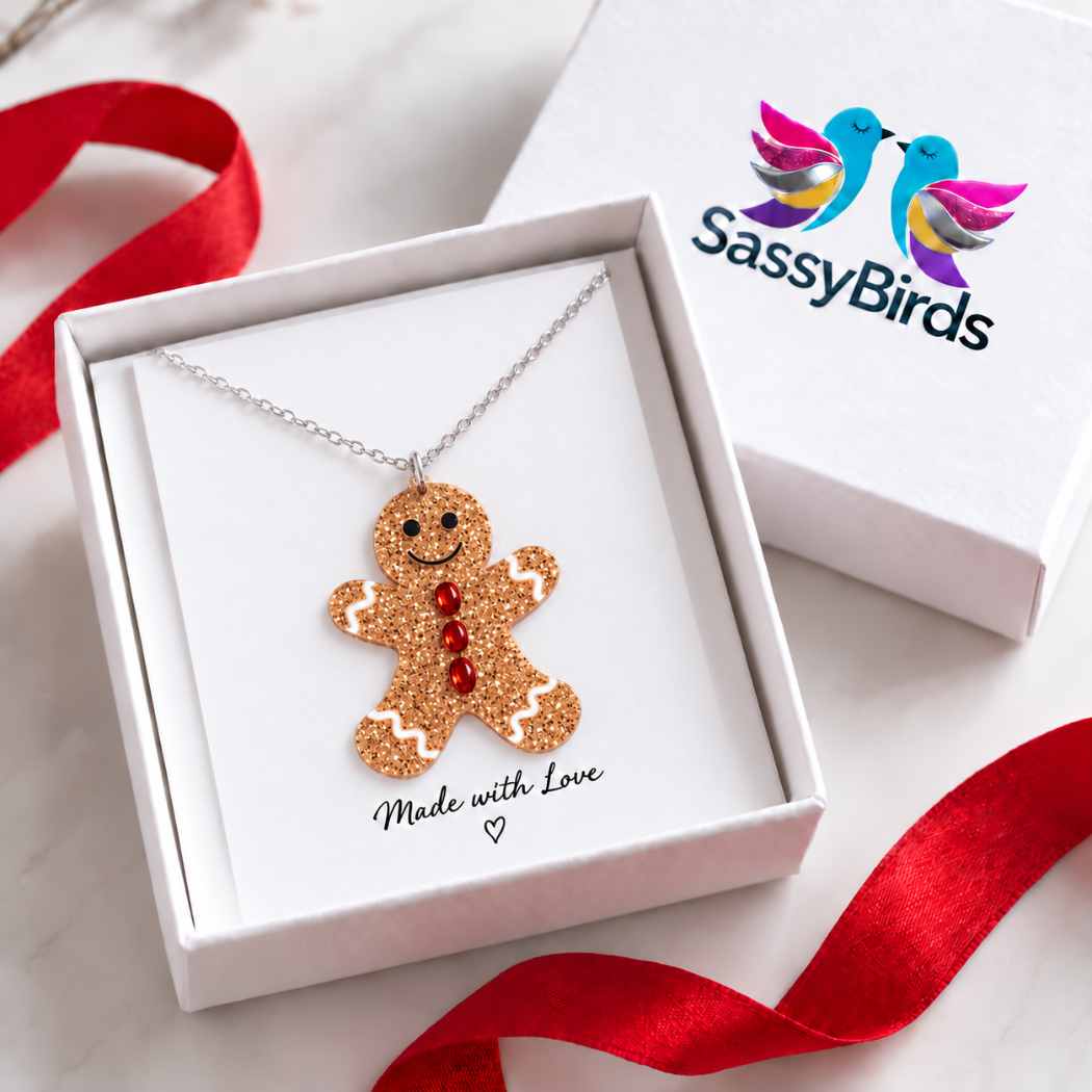 Glitter gingerbread man Christmas necklace with red button details on a silver-tone chain