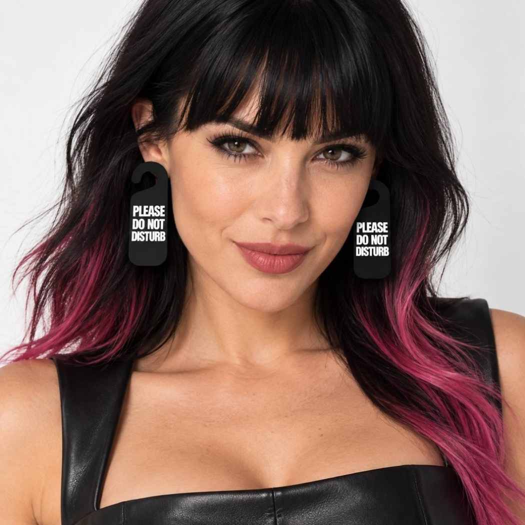 Model wearing black Please Do Not Disturb statement earrings