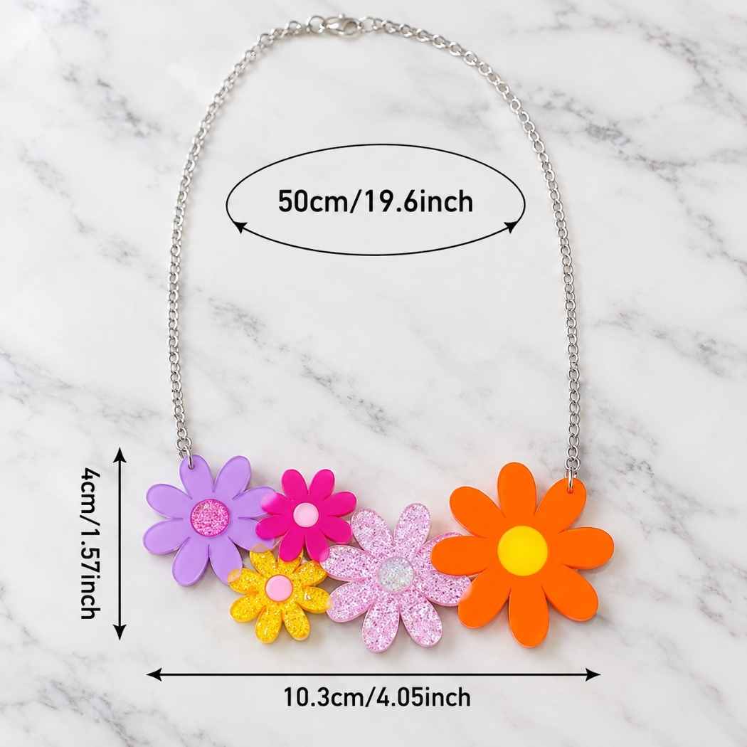 A silver chain necklace with five colorful flower charms in purple, pink, yellow, light pink glitter, and orange, displayed on a white marble background with dimension labels.
